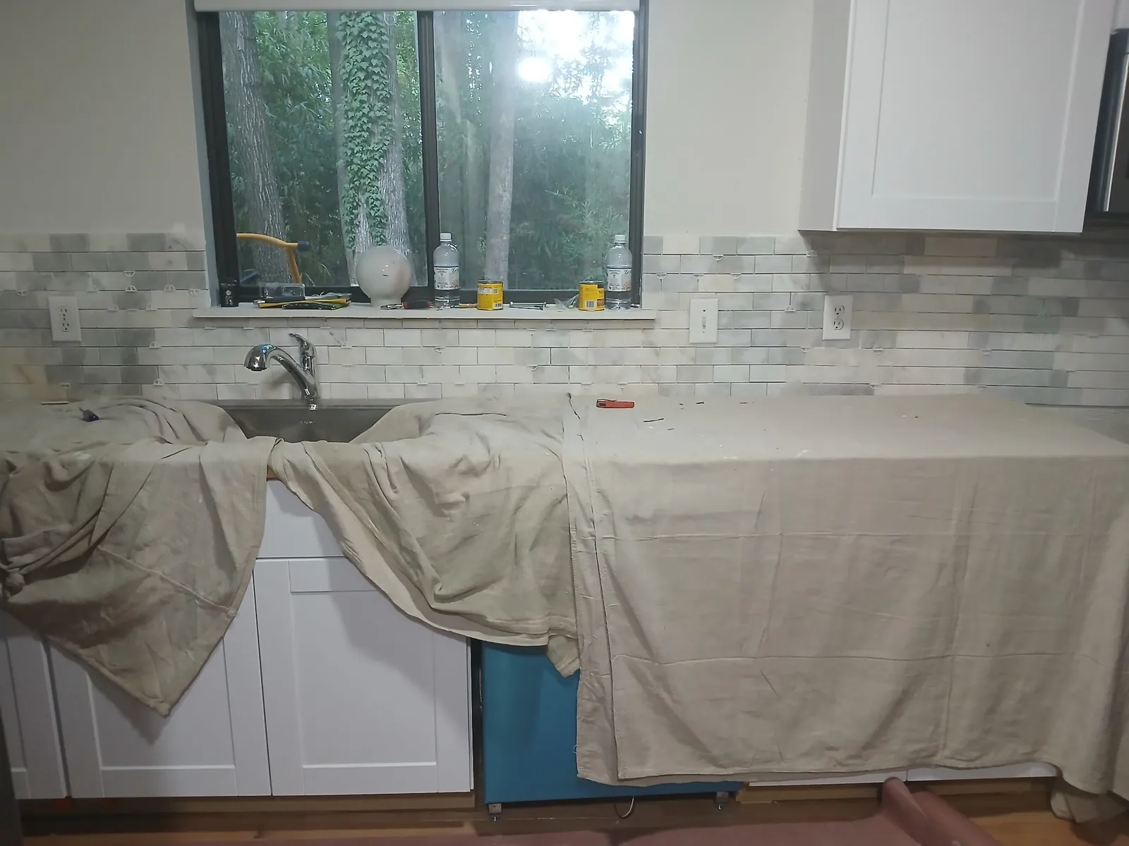 Kitchen sink wall with new faucet, cabinets and backsplash, by Thomas Plumbing & Construction